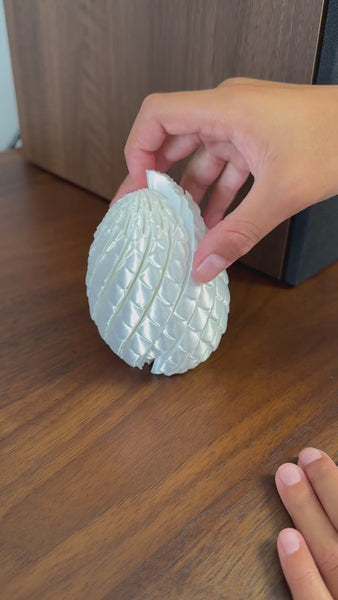 Pearl White Dragon Egg fidget toy folding back into an egg, video demo